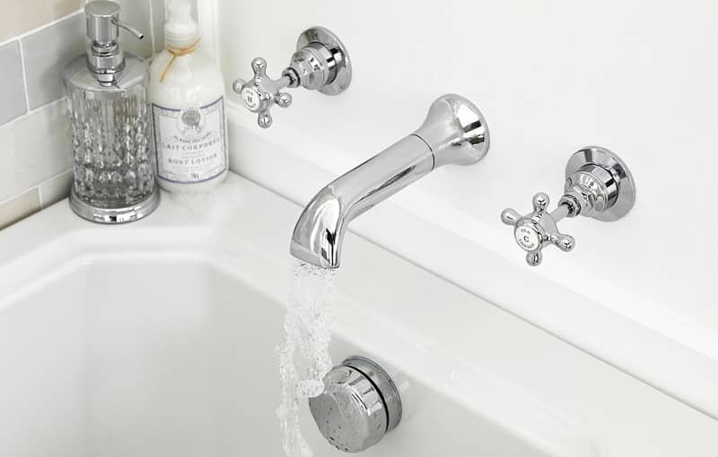 Chrome wall mounted bath spout and traditional tap handles