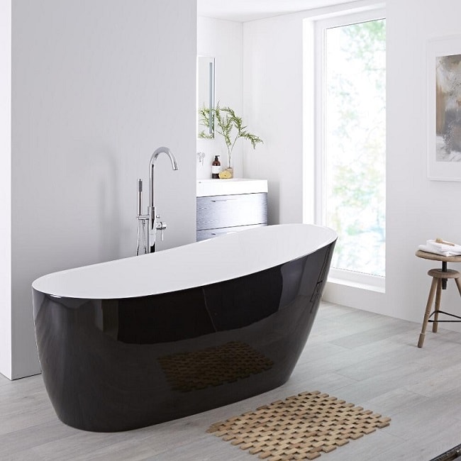 Modern freestanding bath with white interior and black exterior finish.
