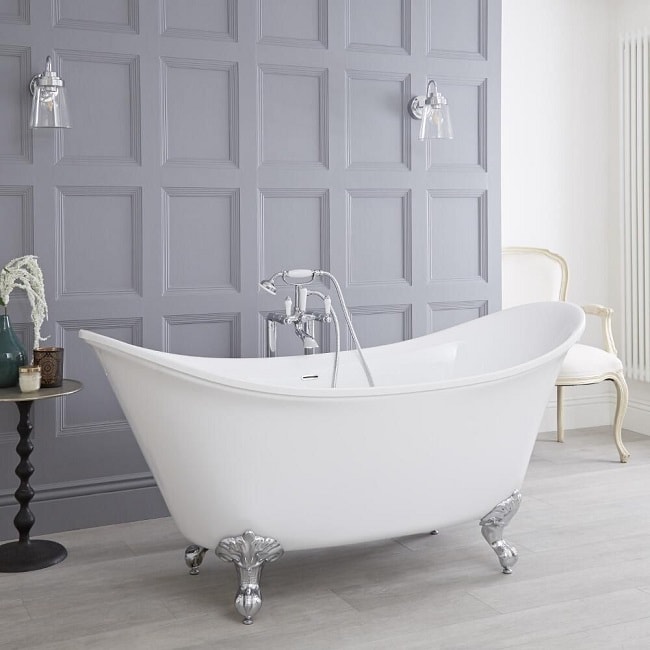 double ended freestanding slipper bath with classic freestanding taps and shower handset in a traditional spacious bathroom