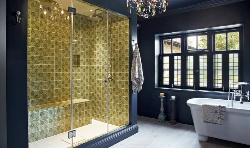 Dark blue bathroom with golden-yellow tiled shower area