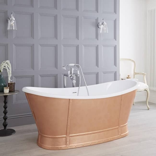 bronze freestanding roll top bath with white interior and freestanding traditional taps