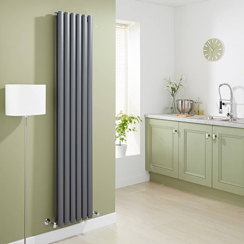 Vertical anthracite designer radiator in an olive green kitchen
