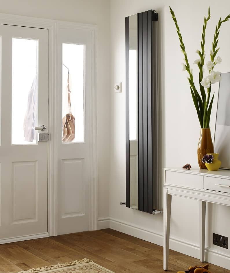 vertical designer radiator with mirror in entrance hallway near front door