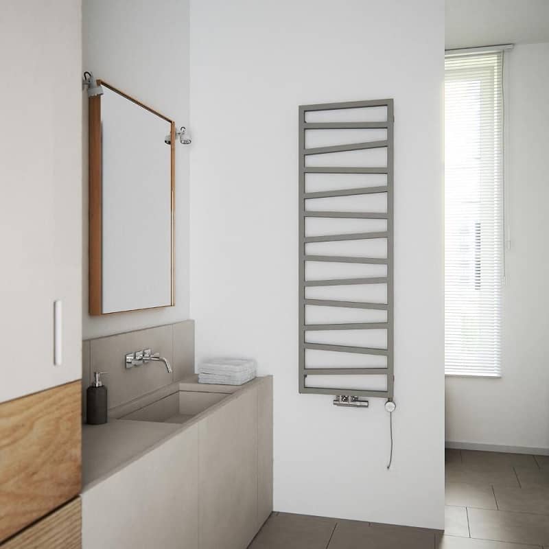 Modern designer towel rail with irregular bars in grey, on a white wall.