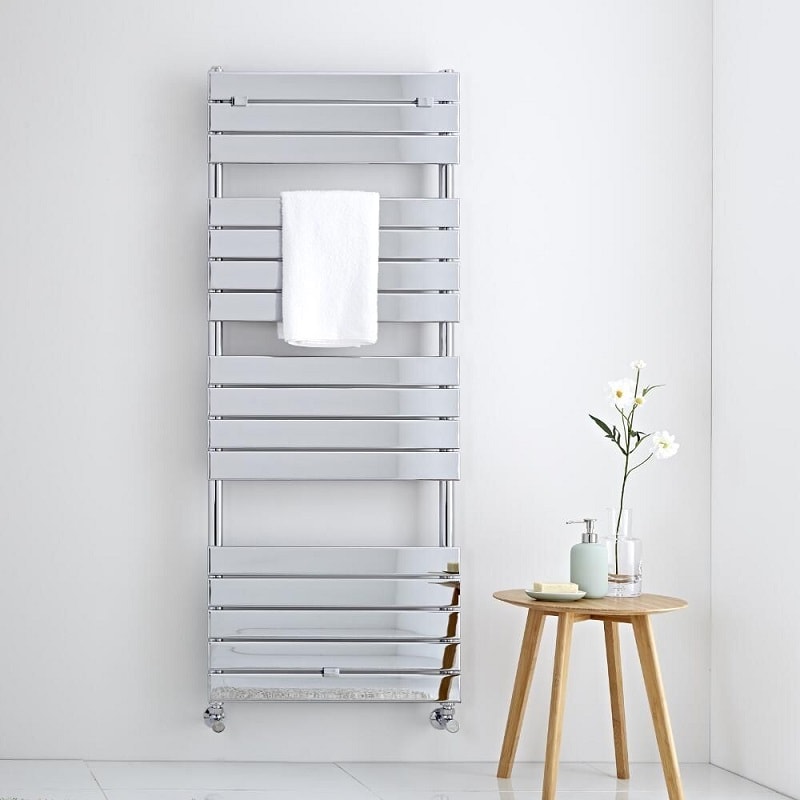 Large chrome heated towel rail on white wall