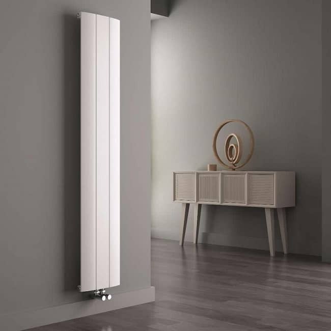 white vertical designer radiator in grey room with natural furniture