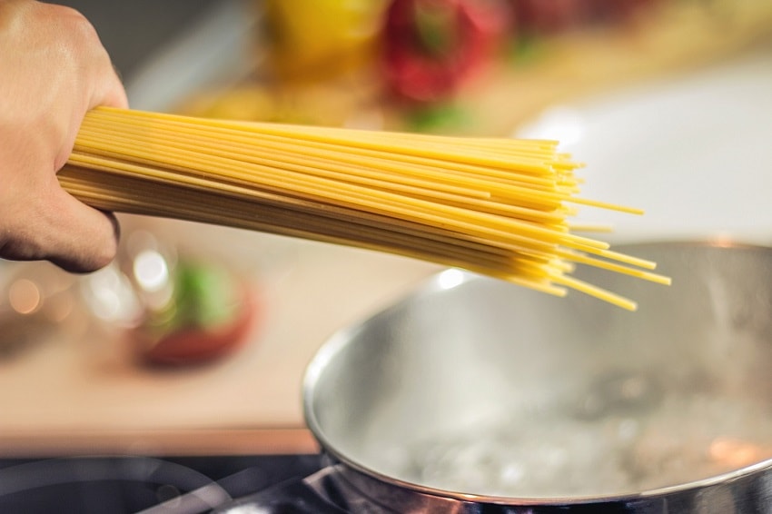 boiling-water-in-pan A handful of spaghetti over a pan of boiling water