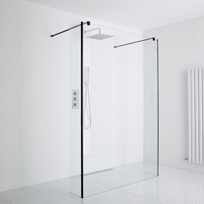 walk in shower with black frame in white room