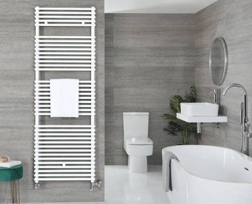 a white towel rail in a grey bathroom next to a bath