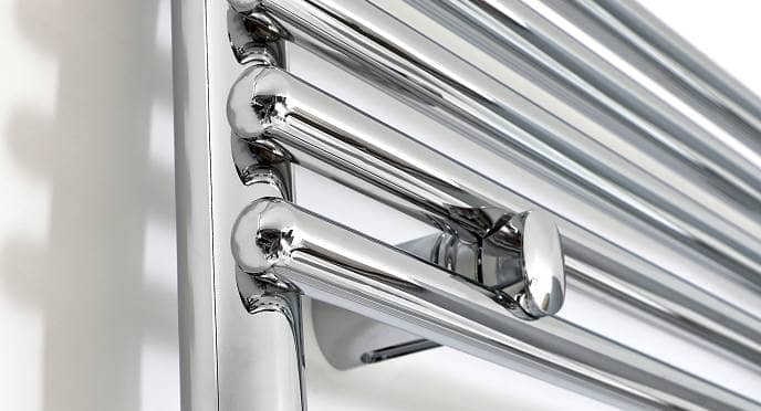 Close up of the chrome panels of a heated towel rail