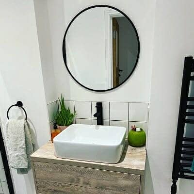 A mirror above a bathroom basin