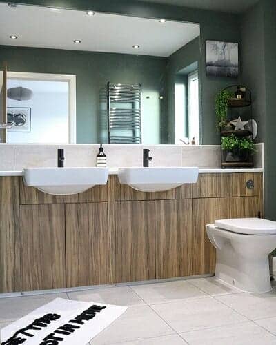 A double basin area with a large mirror in a luxurious bathroom