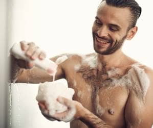 man washing with loofah