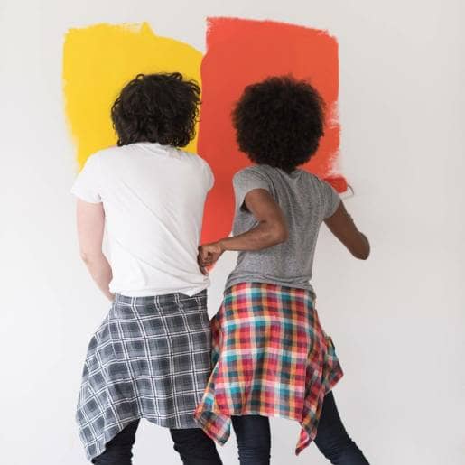 Couple painting bathroom walls