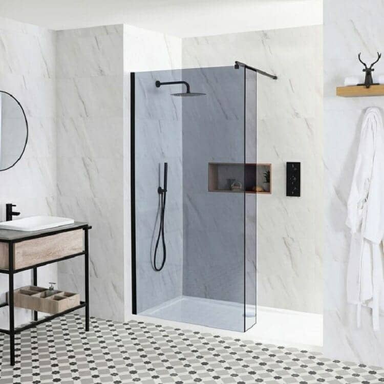 a smoked glass shower enclosure in a marble bathroom space