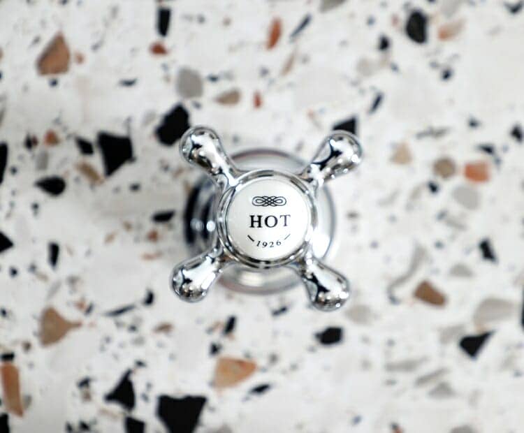 Close up of a shower valve on Terrazzo tile work