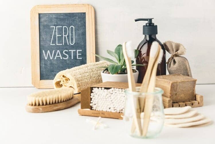 Zero waste, Recycling, Sustainable lifestyle concept. Eco-friendly bathroom accessories: toothbrushes, reusable cotton make up removal pads, make up remover in a glass container, natural brushes, handmade soap, bamboo ear sticks