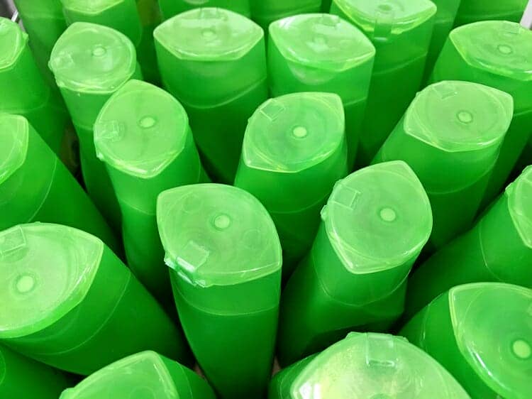 green plastic shampoo bottle