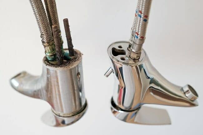 A new and an old faucet or water tap with deposited minerals on the crane aerator