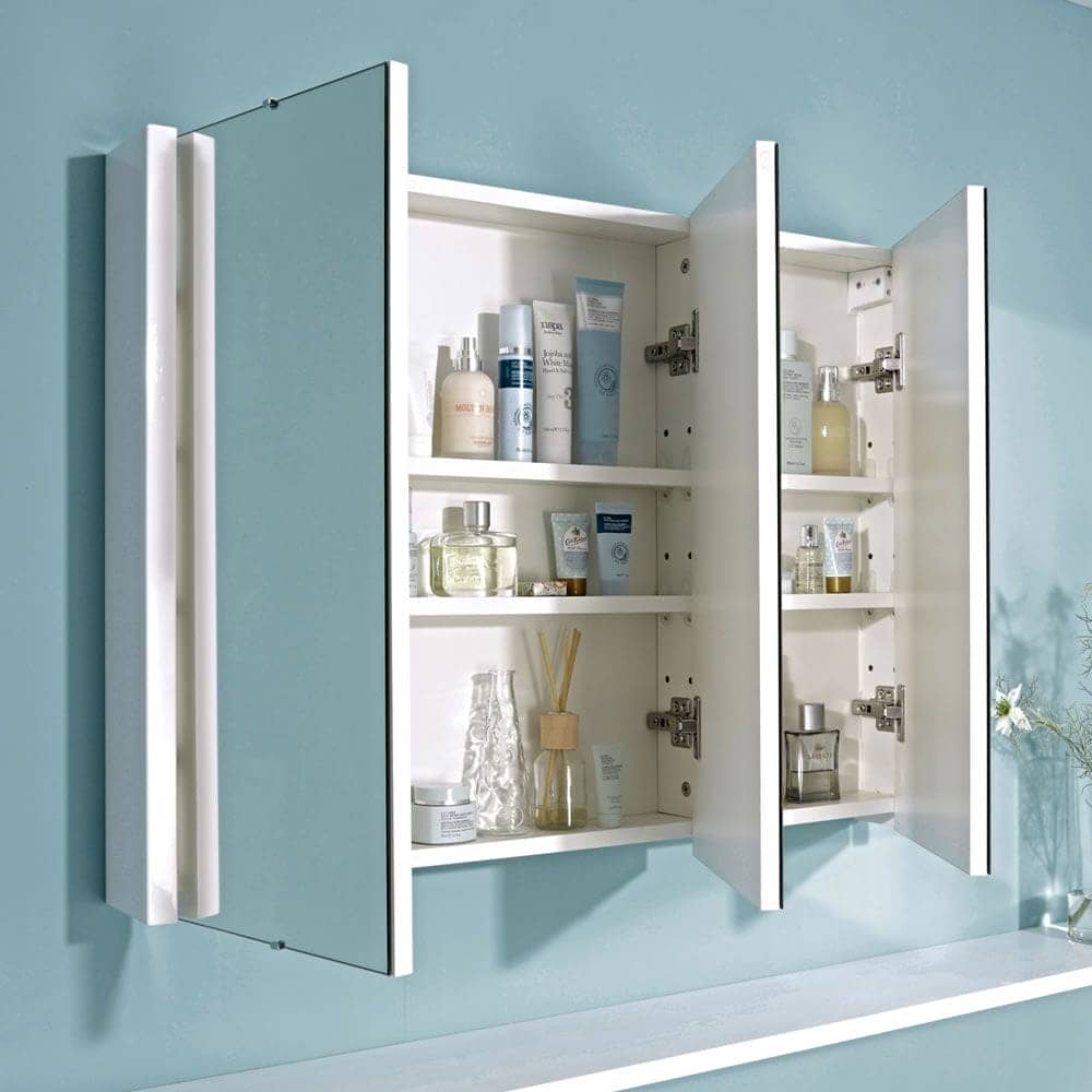 a large mirrored bathroom cabinet in a blue bathroom