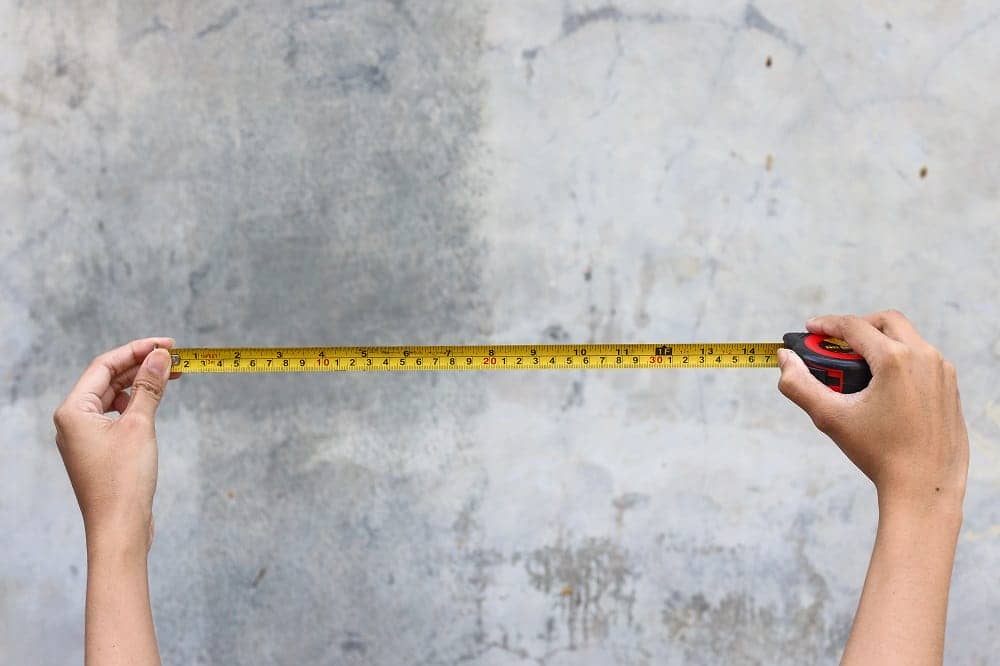 a woman holding a measuring tape